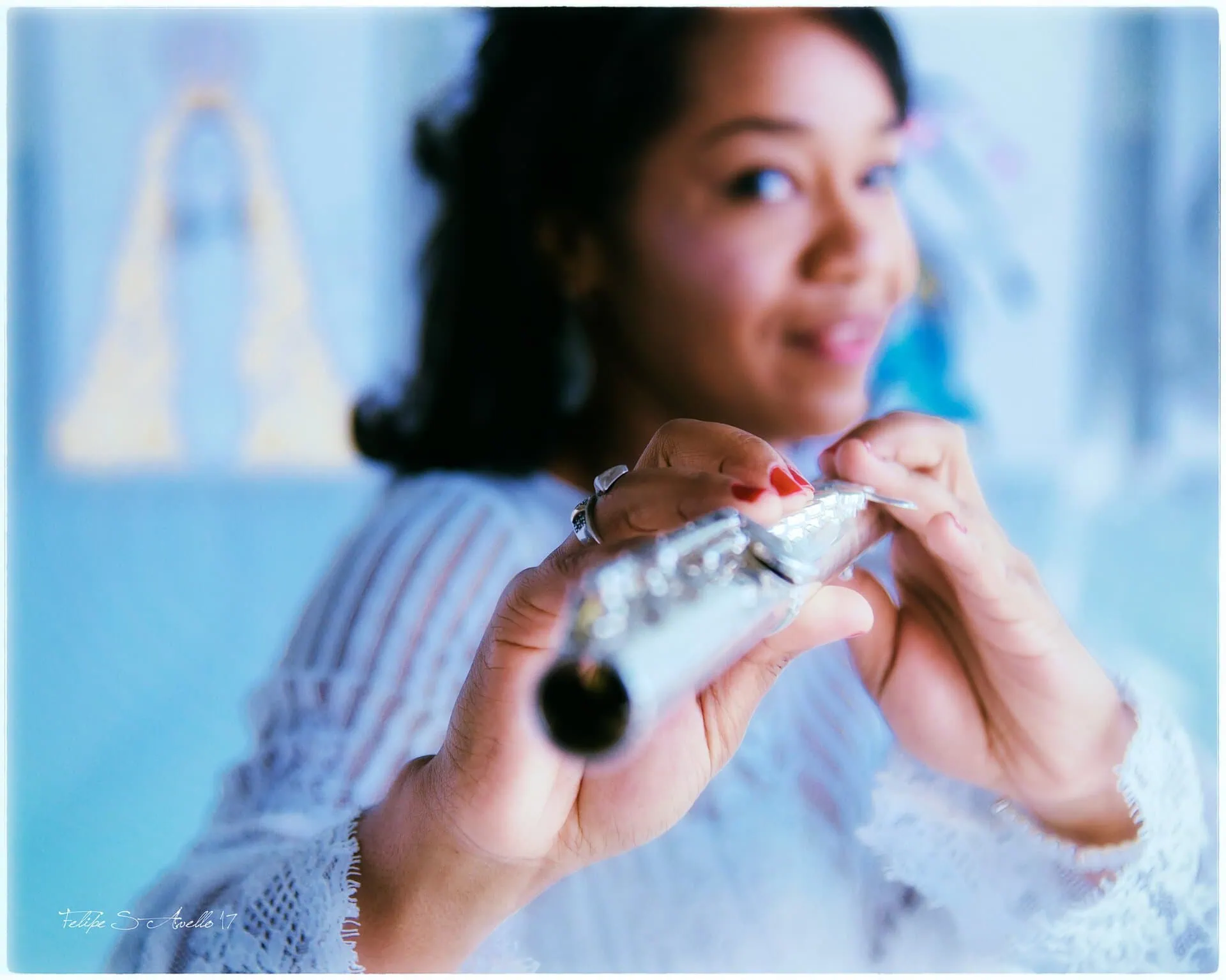Magela Herrera holding her flute toward the camera